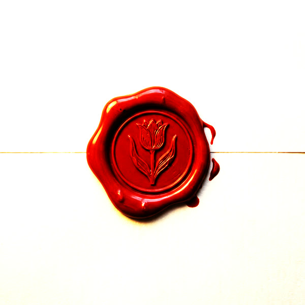 A red wax seal impressed with a tulip, closing the contract.